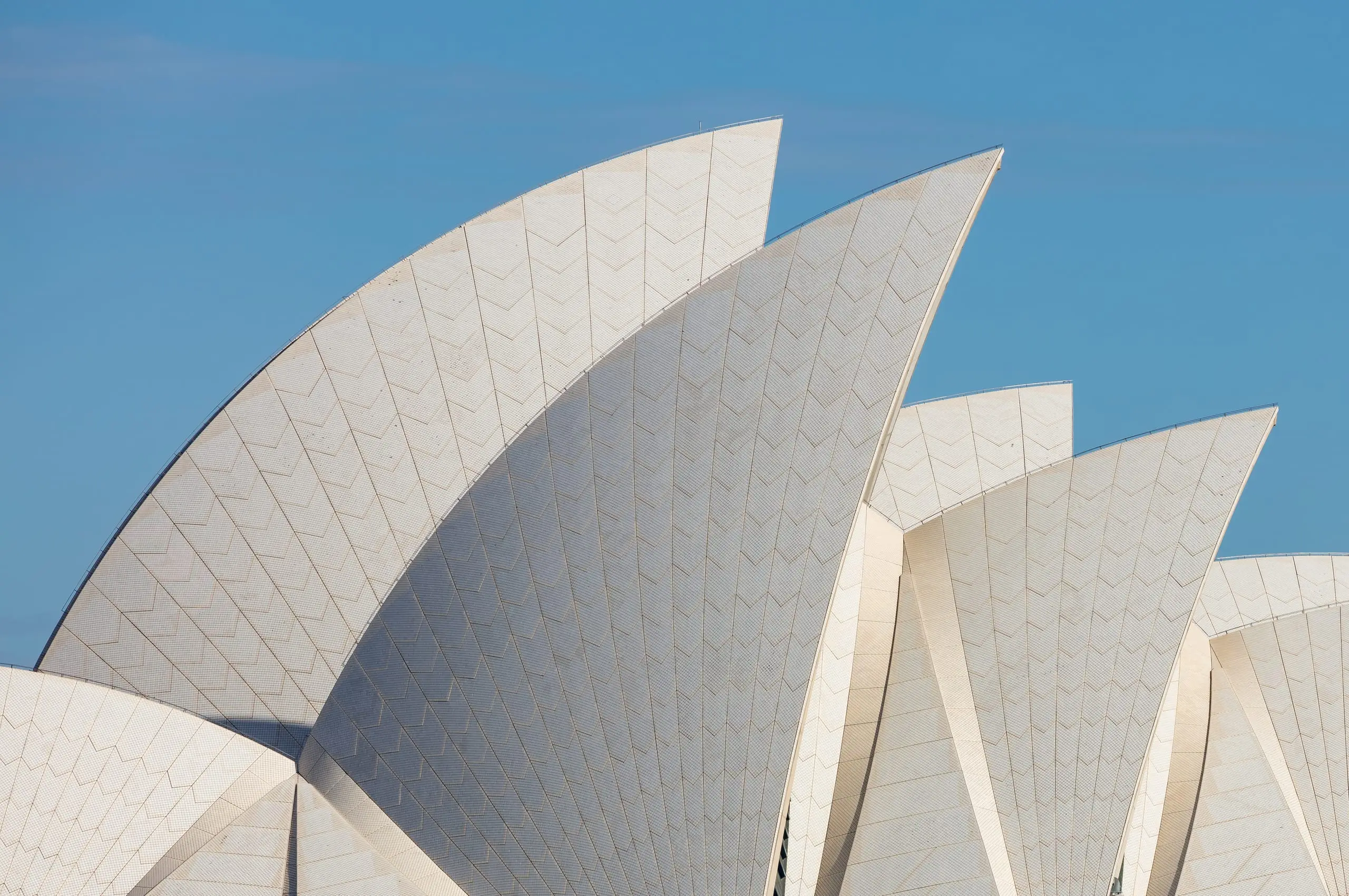 The sails of the Sydney Opera House against a clear blue sky